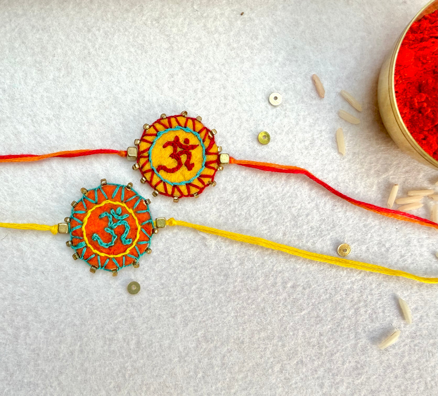 Hand embroidered Aum Mandala Rakhi (Set of 2) Orange-Yellow
