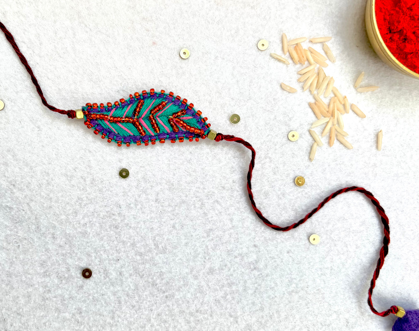 Hand embroidered Leaf Ornamental Rakhi (Sea Green-Pink)