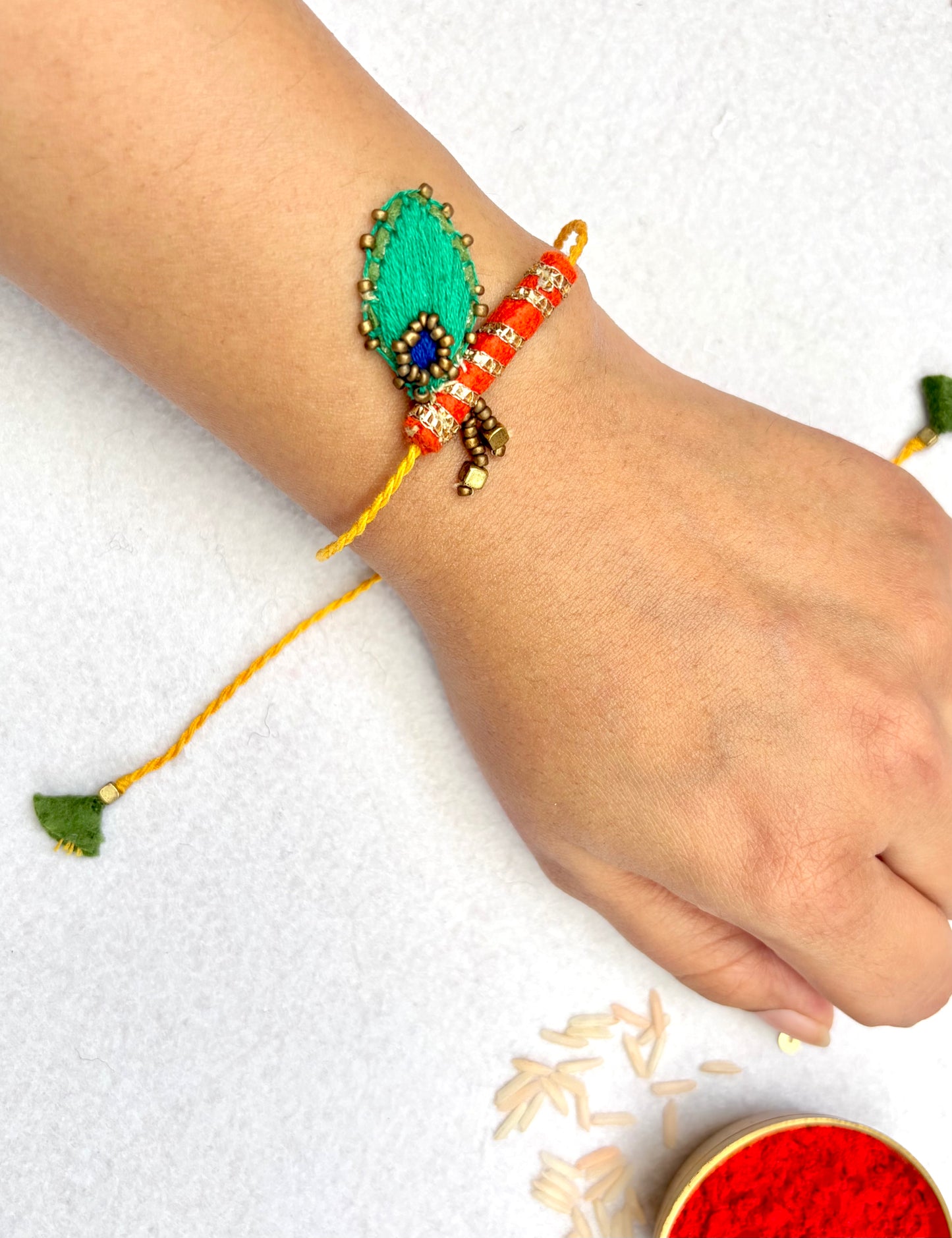 Radha Bansuri Rakhi Lumba Set (Set of 2)- Green-Orange