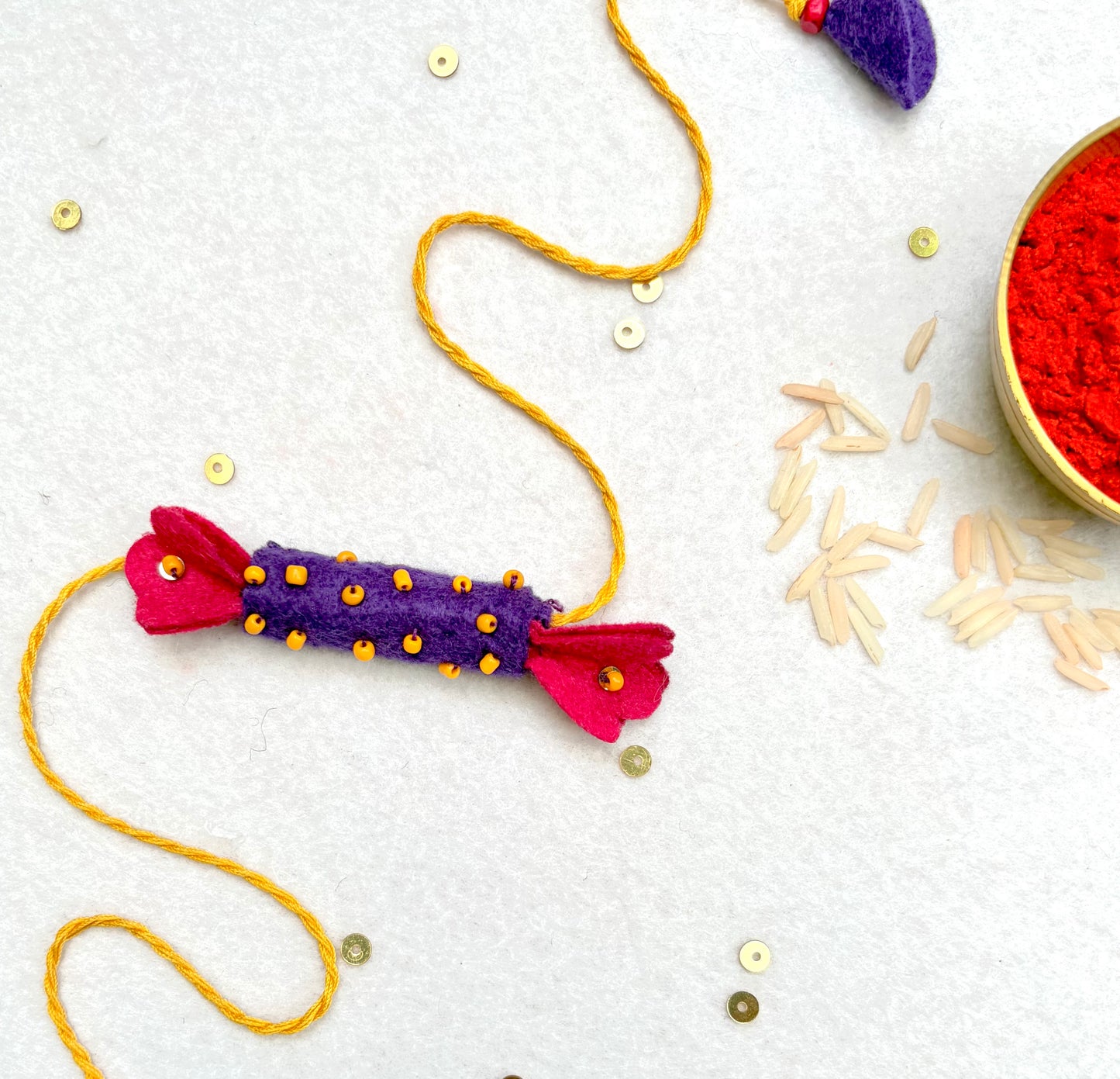 Hand embroidered Candy Rakhi-Purple