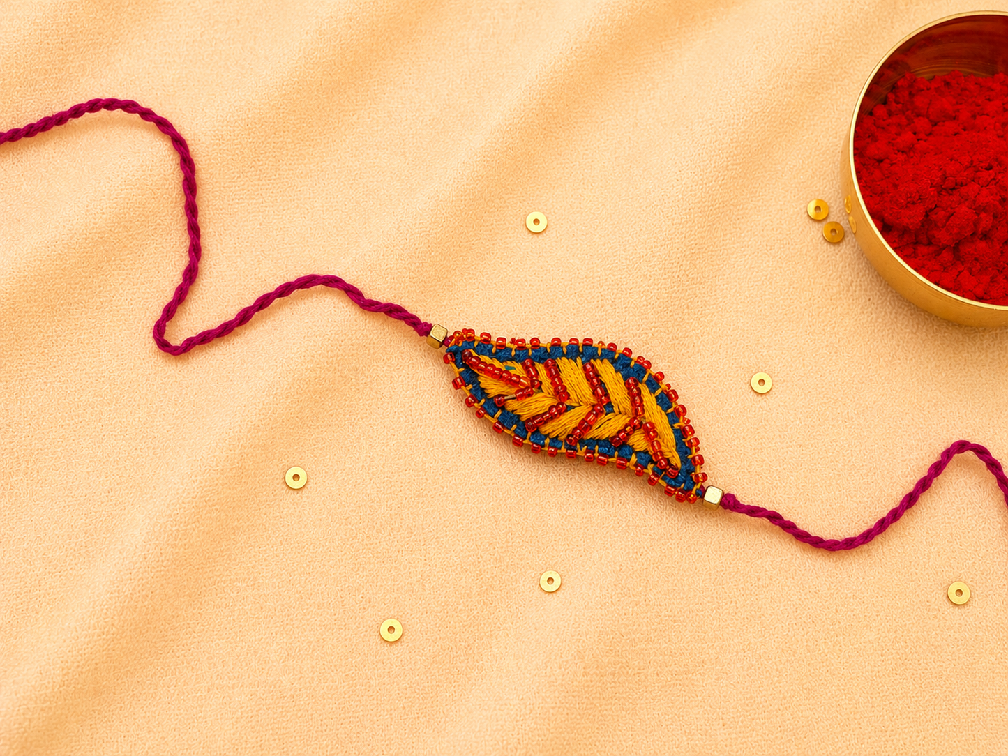 Hand embroidered Leaf Ornamental Rakhi (Yellow)