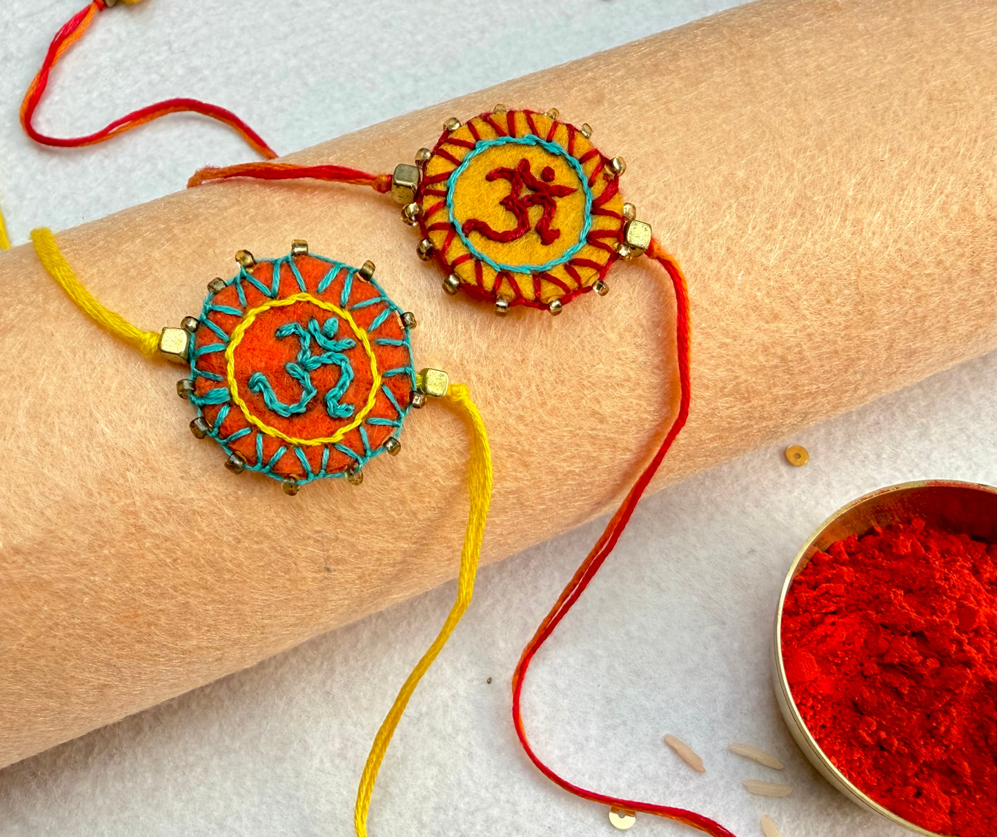 Hand embroidered Aum Mandala Rakhi (Set of 2) Orange-Yellow