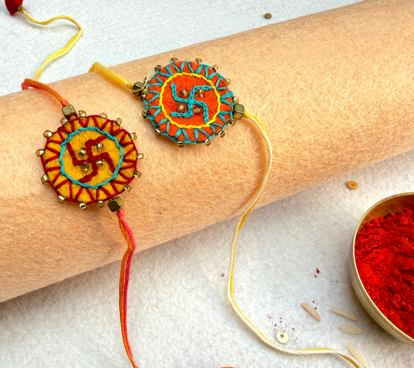 Hand embroidered Swastika Mandala Rakhi (Set of 2) Yellow-Orange