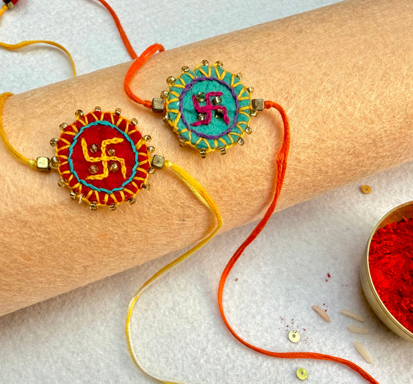Hand embroidered Swastika Mandala Rakhi (Set of 2) Red-Sea Green