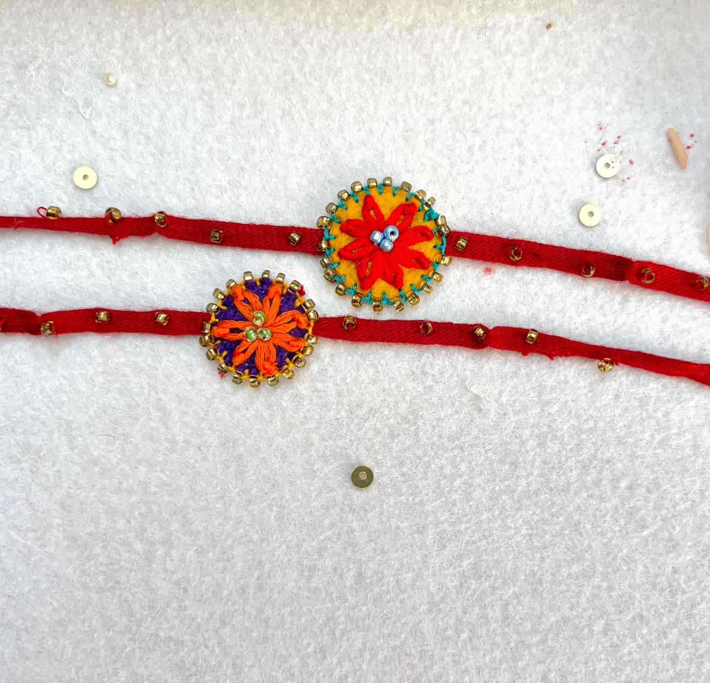 Hand embroidered Flower daisy Rakhi (Set of 2) Red-Orange