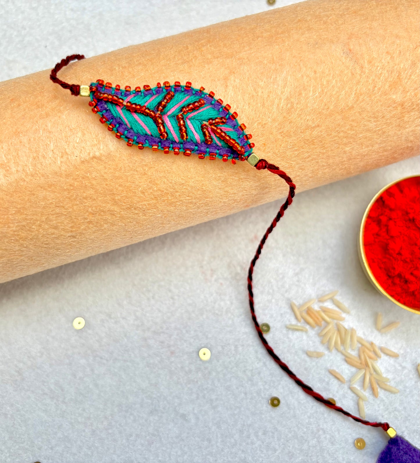 Hand embroidered Leaf Ornamental Rakhi (Sea Green-Pink)