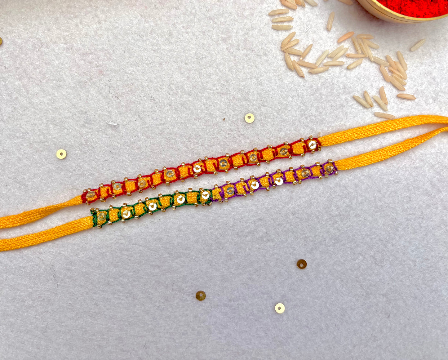 Hand embroidered Blanket Sequin Rakhi (Set of 2)- Red-Purple Green