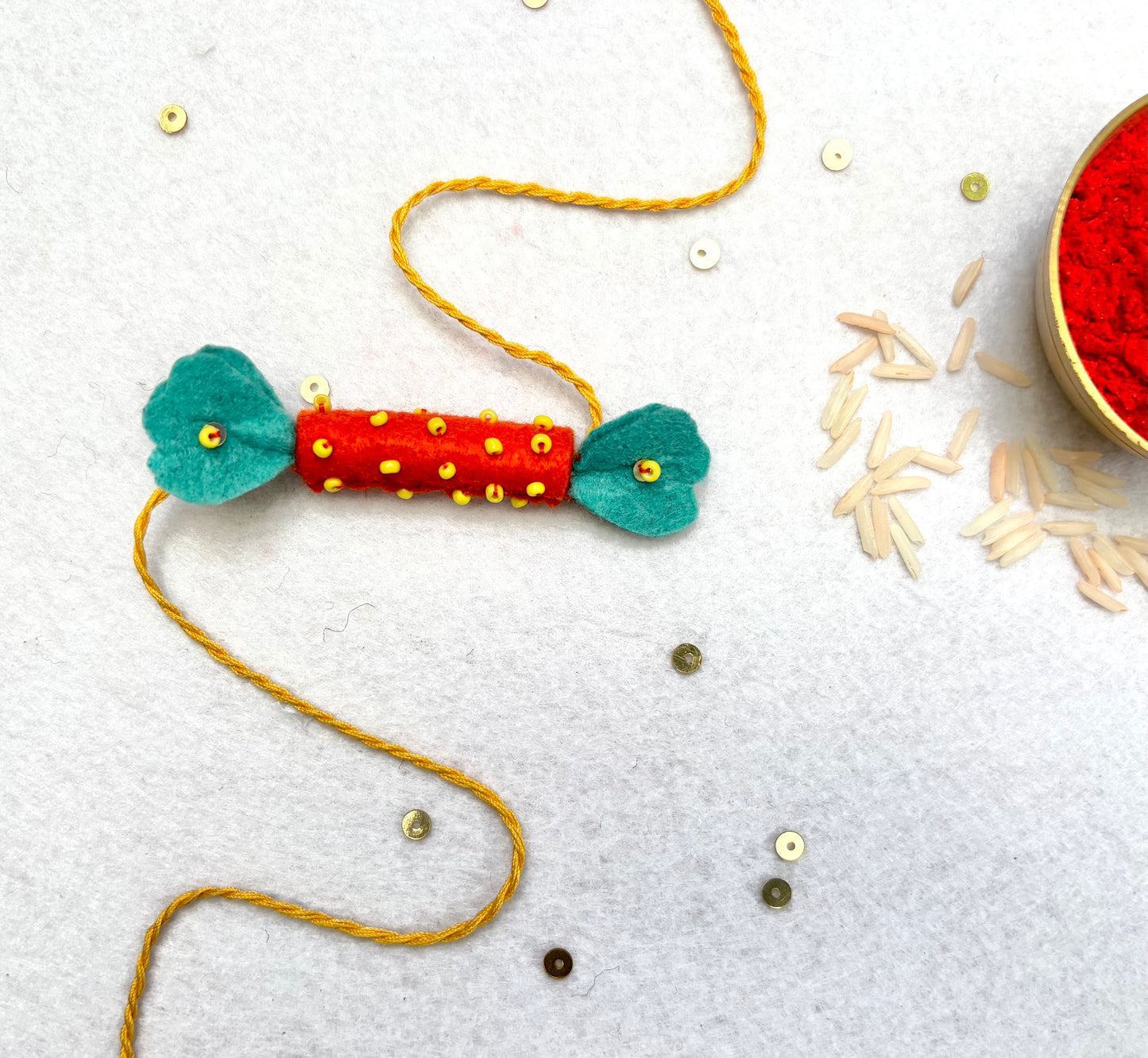 Hand embroidered Candy Rakhi-Orange